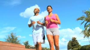 stock-footage-attractive-african-american-couple-jogging-on-suburban-roads-to-keep-fit